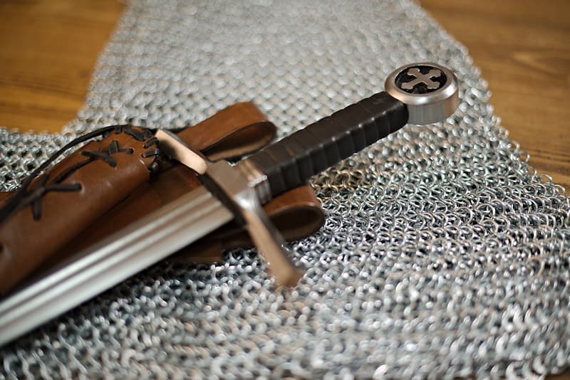 Striking sword, pommel with trefoil cross and laced brown leather scabbard, slant carry