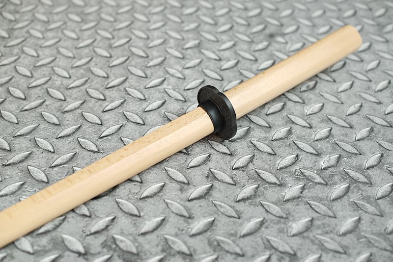 Bokken (木剣 wooden training katana, bokutō (木刀) in Japan), with tsuba held by an elastic ring