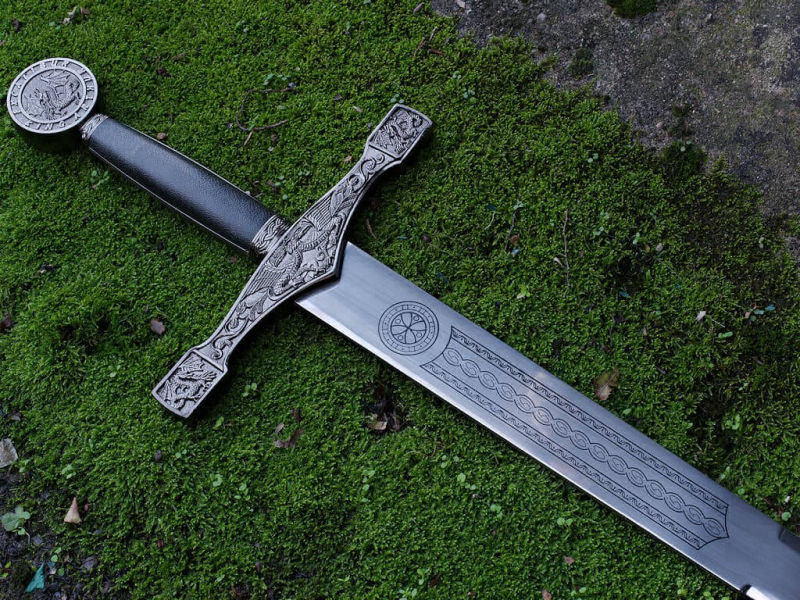 The Excalibur sword, King Arthur's legendary weapon, laid from natural moss The Excalibur sword, King Arthur's legendary weapon, laid from natural moss
