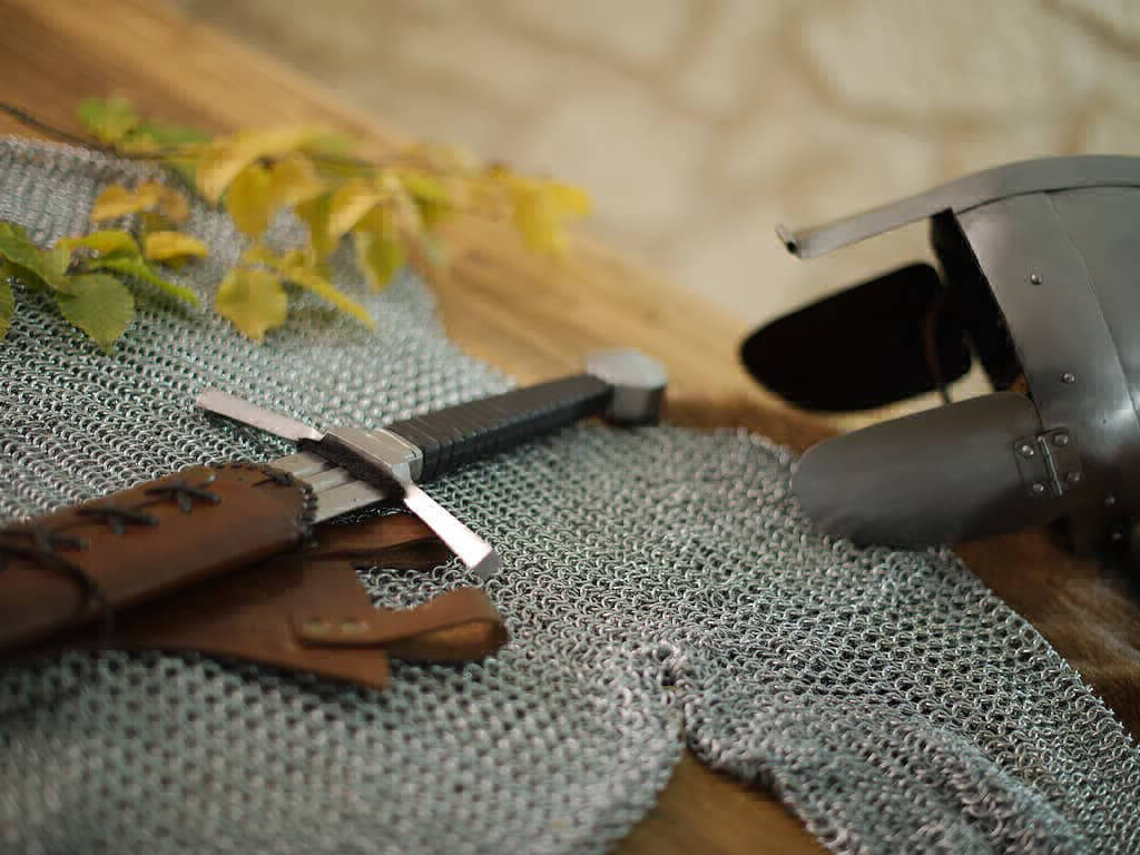 Staging medieval chain mail with helmet and fighting sword