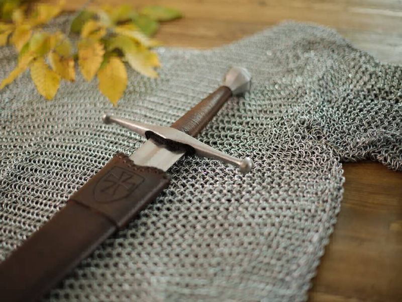 Medieval battle sword mounted on chain mail