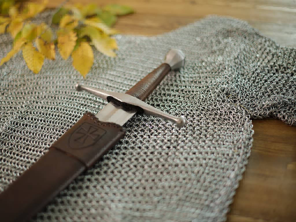 Medieval battle sword mounted on chain mail