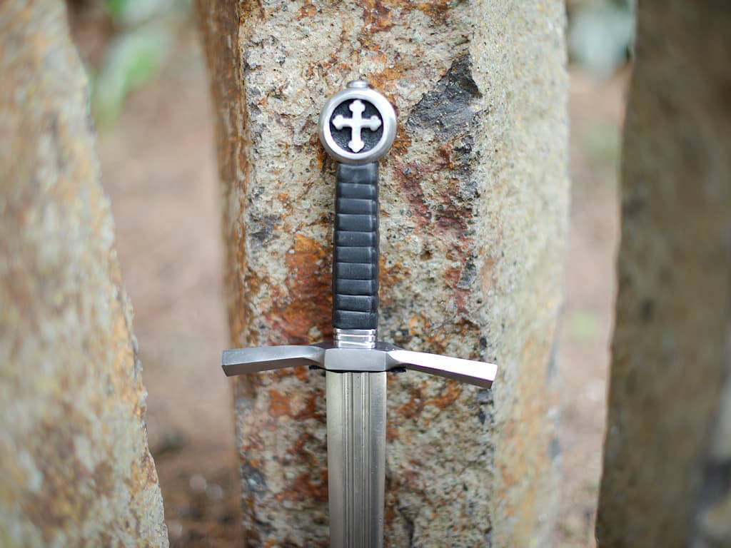 Medieval Crusader knight's dagger set on vertical natural stones