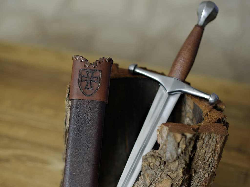 Medieval German dagger and scabbard set on natural bark