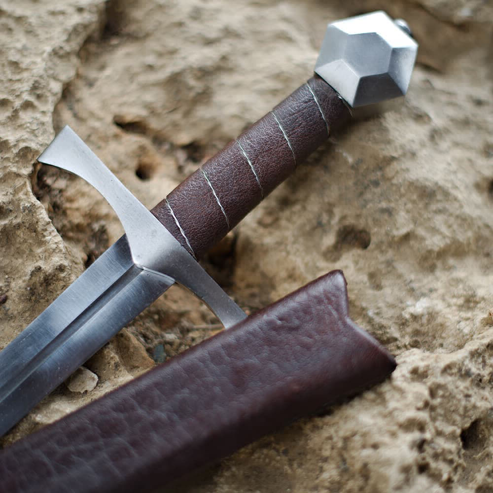 Medieval "Lightbane" combat dagger on a rock