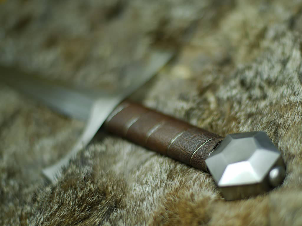 Medieval "Lightbane" combat dagger on natural skin