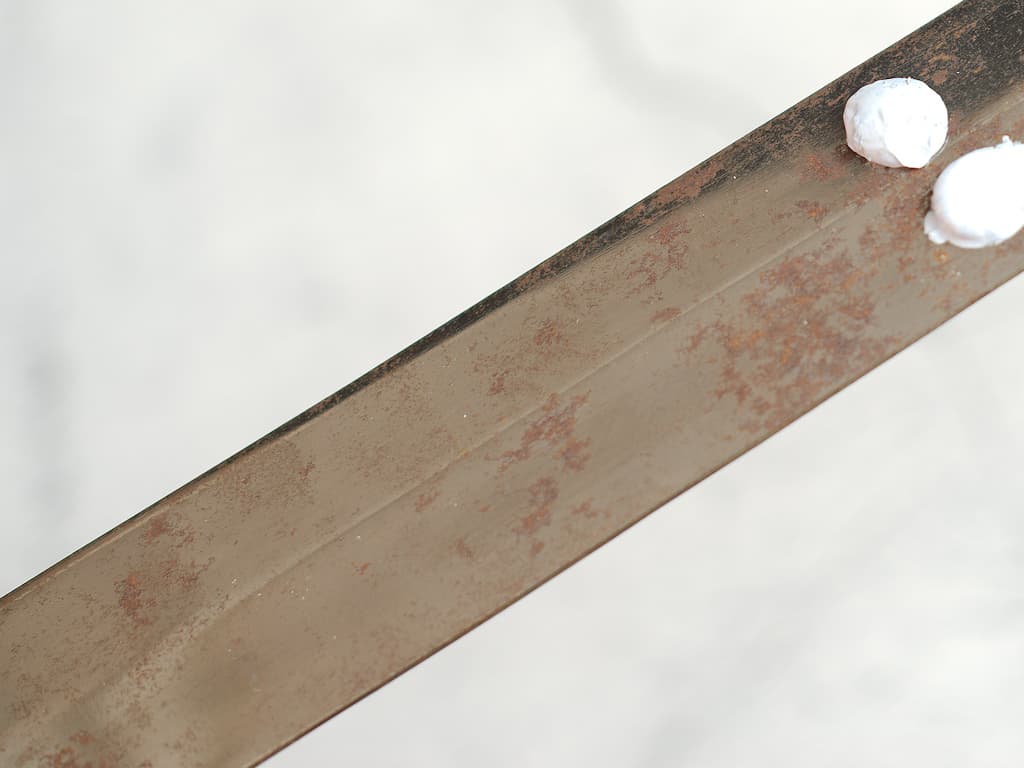 Apply polishing paste to metal.