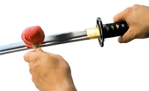 Figure 2: Tapping the Uchiko on the blade to deposit limestone powder