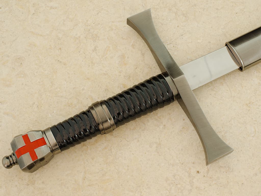 A hand protected by a medieval gauntlet takes possession of the decorative Templar sword. Templar sword "Return from the Holy Land" #Terressens